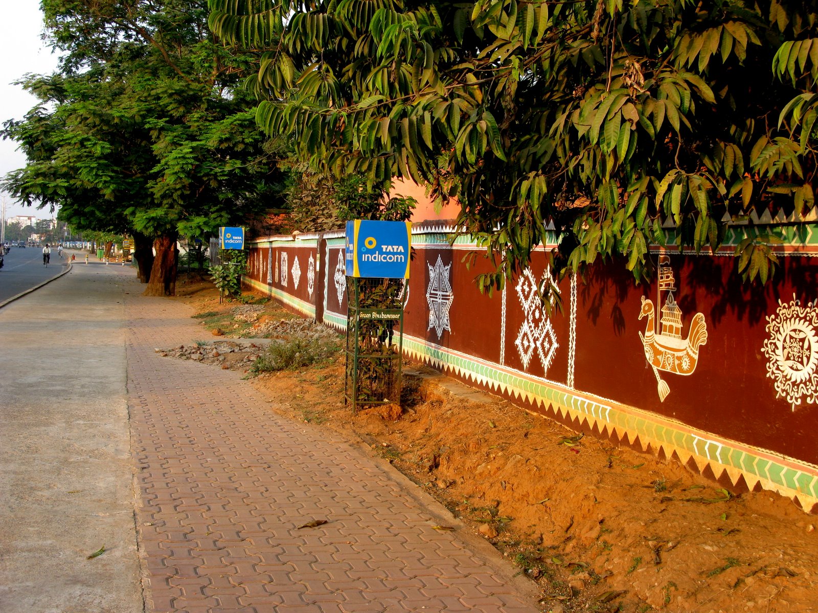 Tree-lined pavement and painted wall
